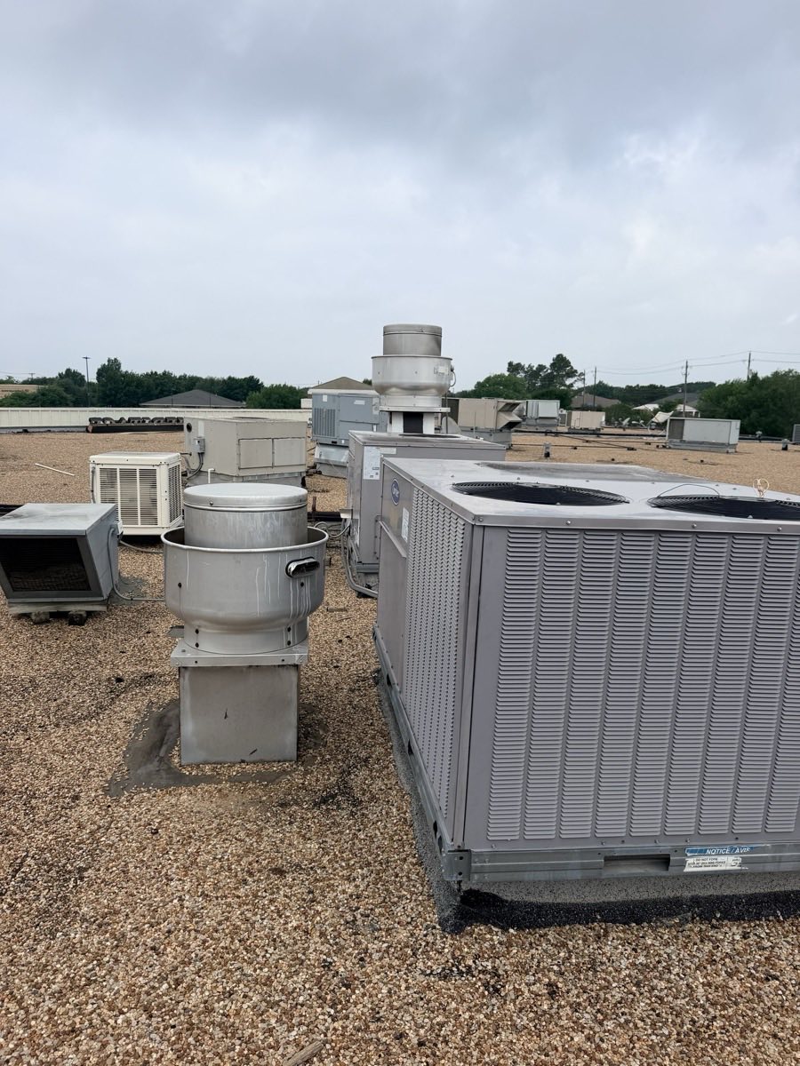 Multiple commercial rooftop HVAC and refrigeration units on one DFW property during a maintenance visit