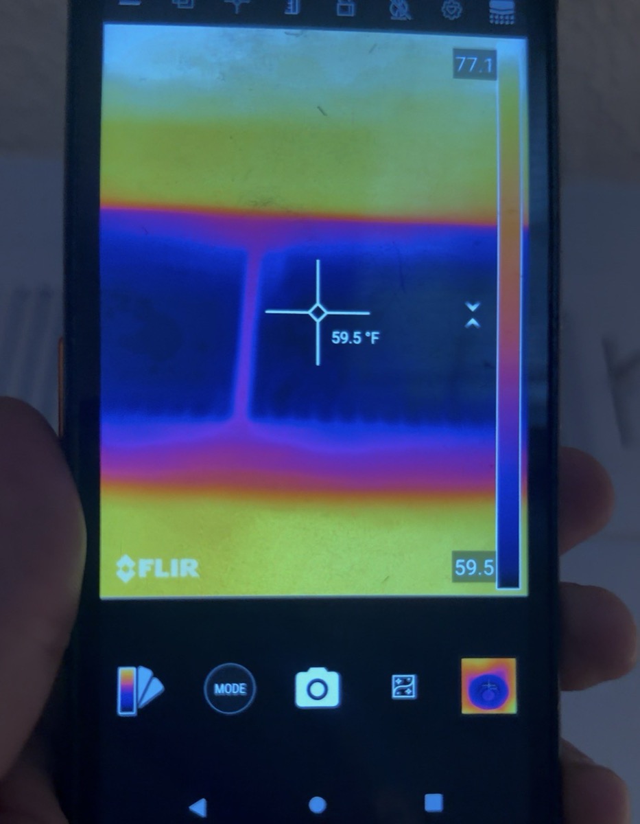 Thermal camera reading of a ceiling supply register at 59.5 degrees Fahrenheit against a 77.1 degree ceiling during an air conditioning diagnostic