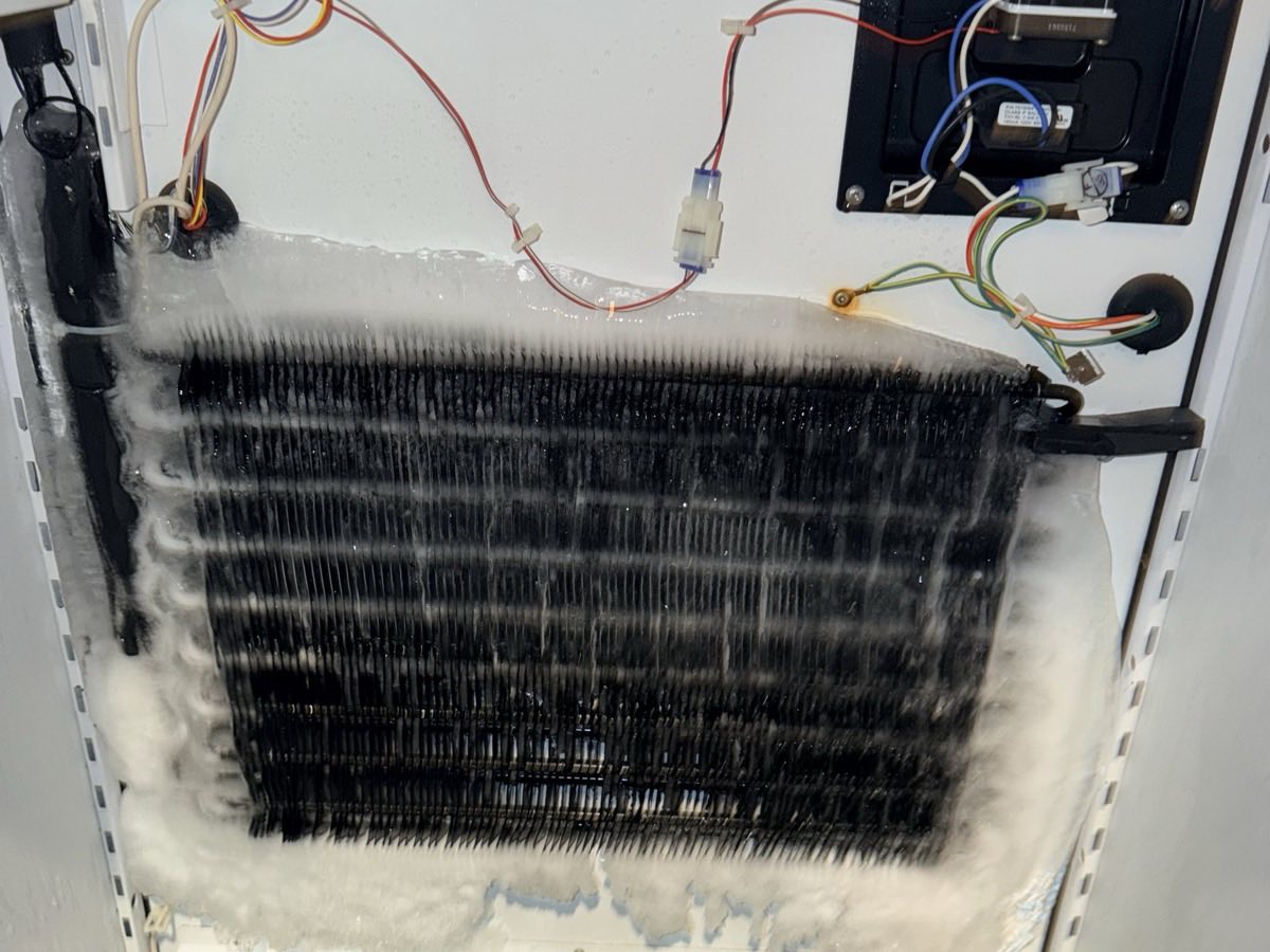 Refrigerator evaporator coil packed with ice behind the rear panel after a defrost system failure
