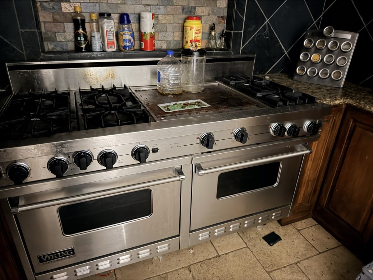 Viking professional gas range with sealed burners, centre griddle and double ovens in a DFW kitchen during a service call